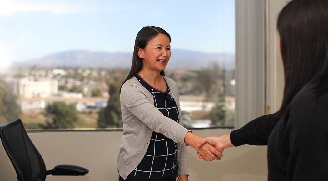 two people shake hands