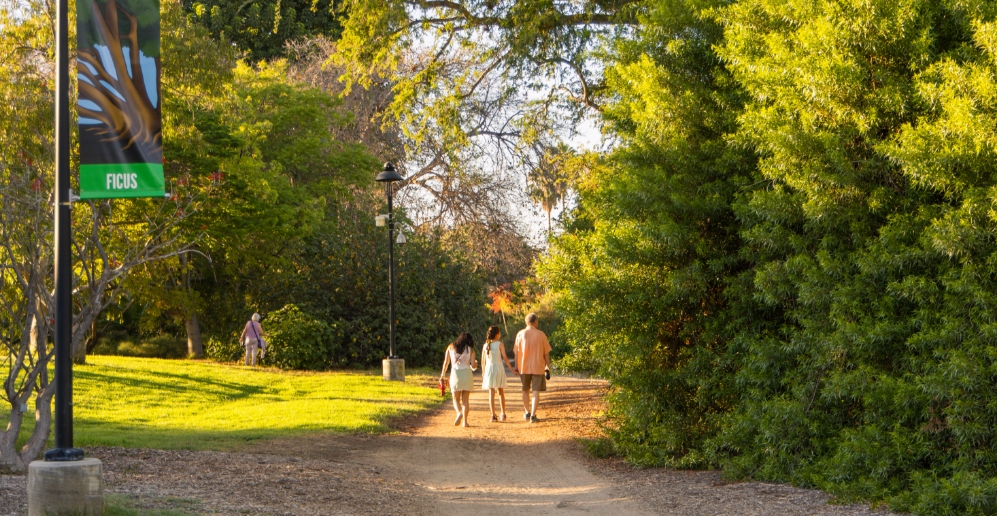 A family walking around Fullerton Arboretum