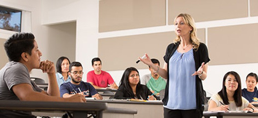 female teacher lecturing students in classroom