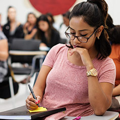 Student writing in notebook