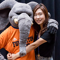 International student embracing CSUF mascot Tuffy the elephant