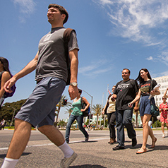 View of many students walking to and from classes on one of paths at CSUF