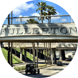 View of bridge in Fullerton above streets that reads 'FULLERTON'