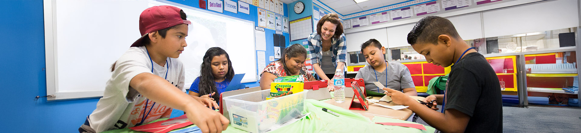 a young female instructor is teaching in a class with children