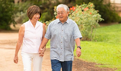 senior citizens walking in park