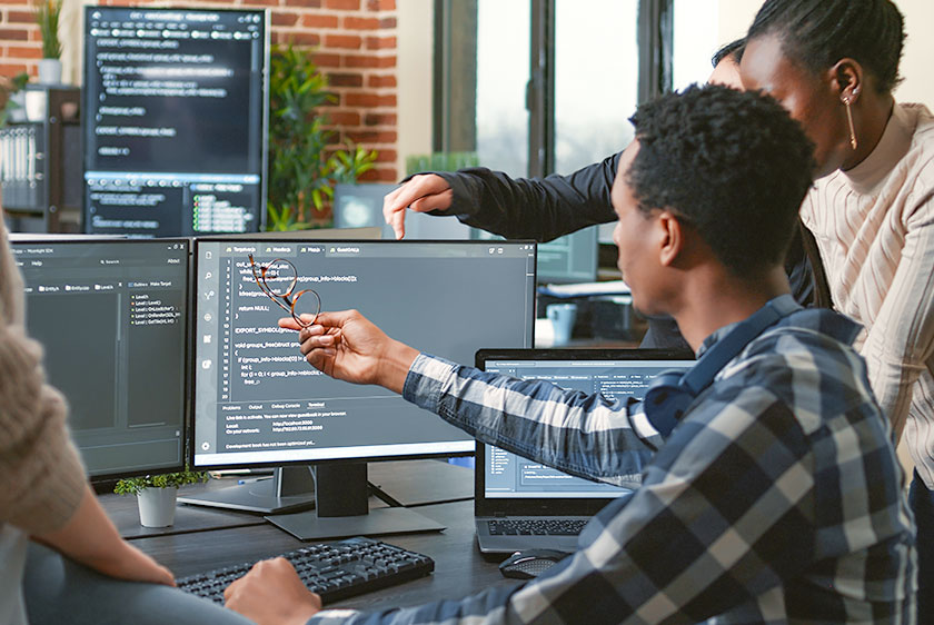 a group of people working on a computer project