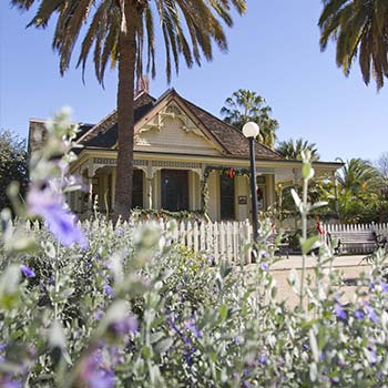 flowers in front of heritage house