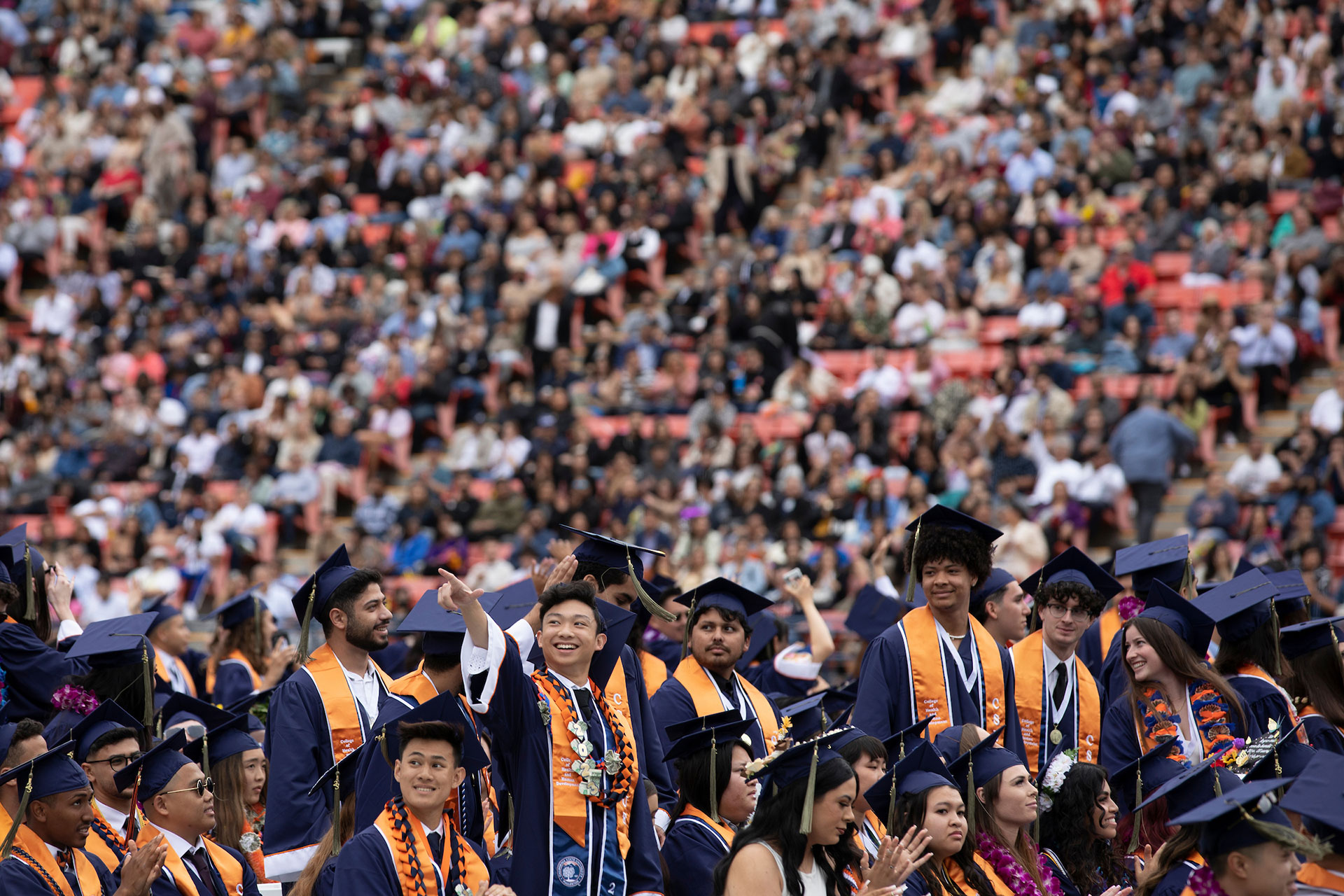 A group of CSUF graduates in caps and gowns