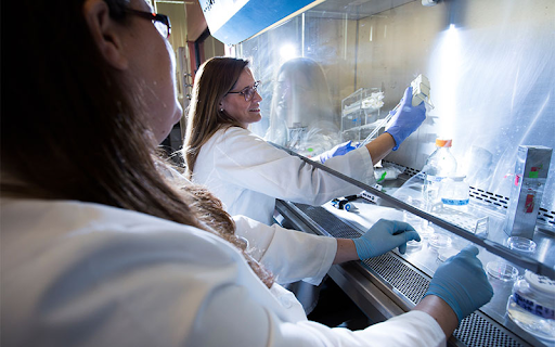 TWo females working with samples in a lab