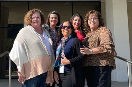 Margaret Luzzi, Suzanne Batista, Gail Wright, Michelle Hernandez, and Karen McKinley standing outside Titan Hall