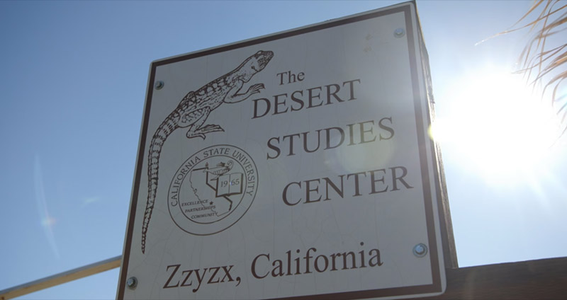 Sign for The Desert Studies Center in Zzyzx with bright sunlight