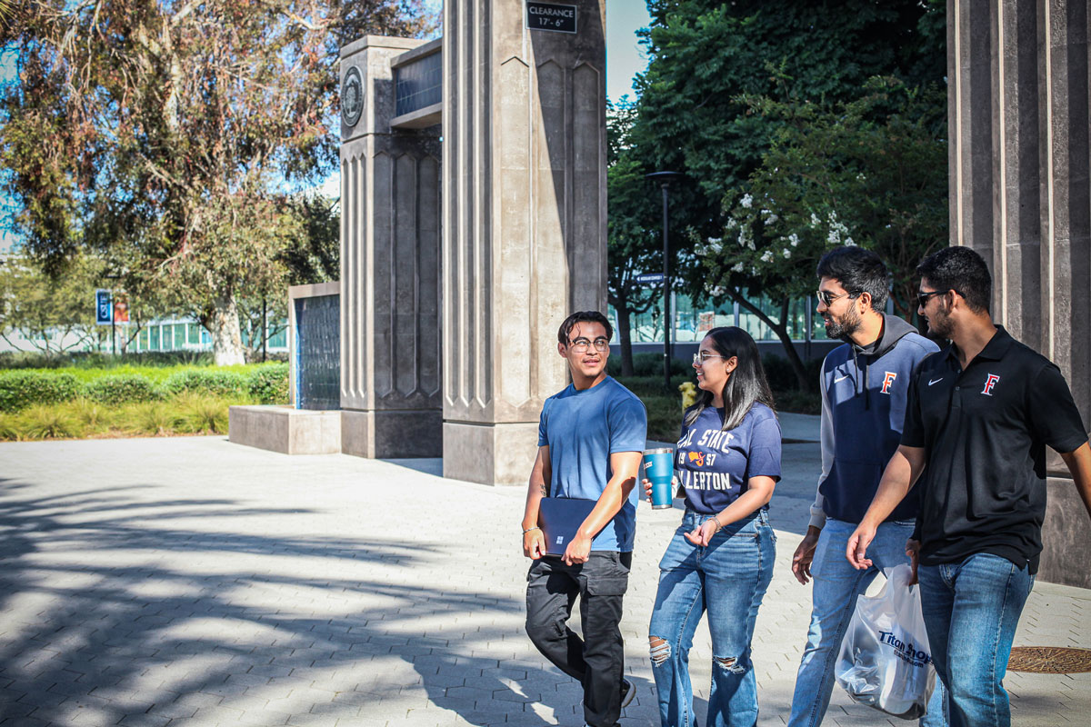 International students walk on campus in front of the main entrance